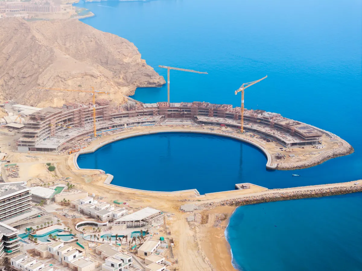 The wider bay at The Sustainable City - Yiti, showing The Arc, the marina basin and the coastline