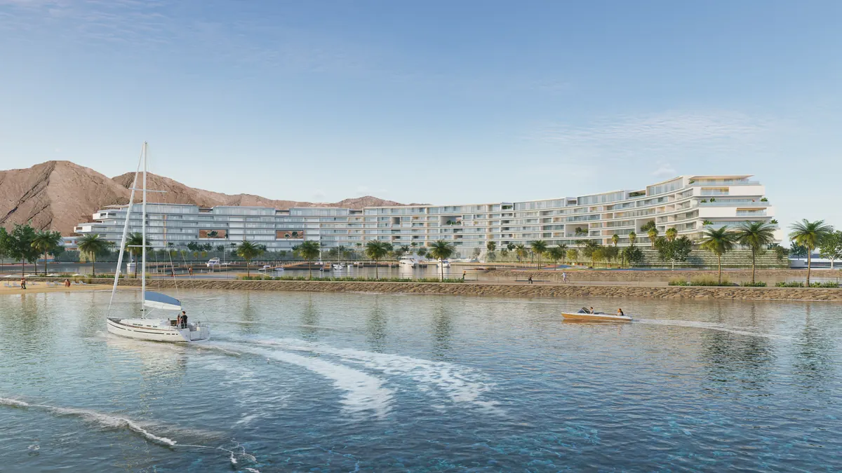 The Arc seen across its marina, berths and moored boats along the curve of the building