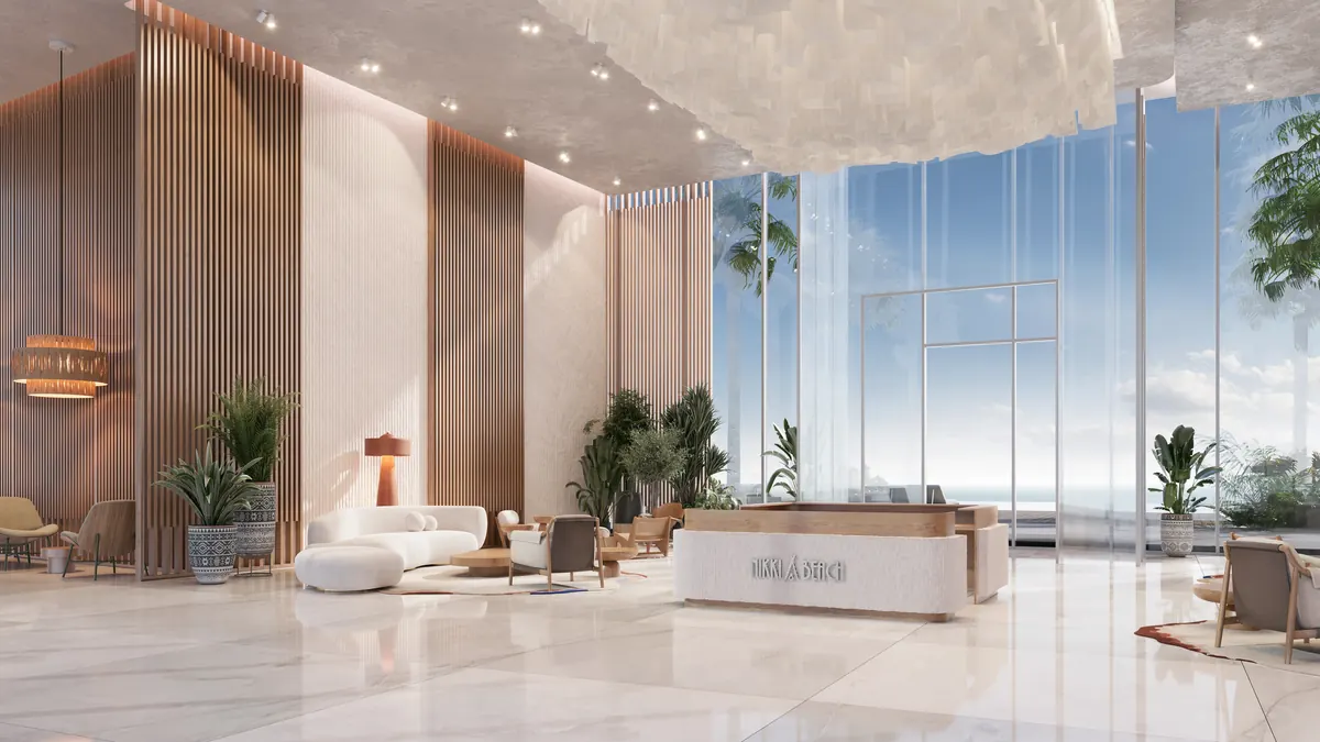 The residents lobby at The Arc, a double height space opening to the marina