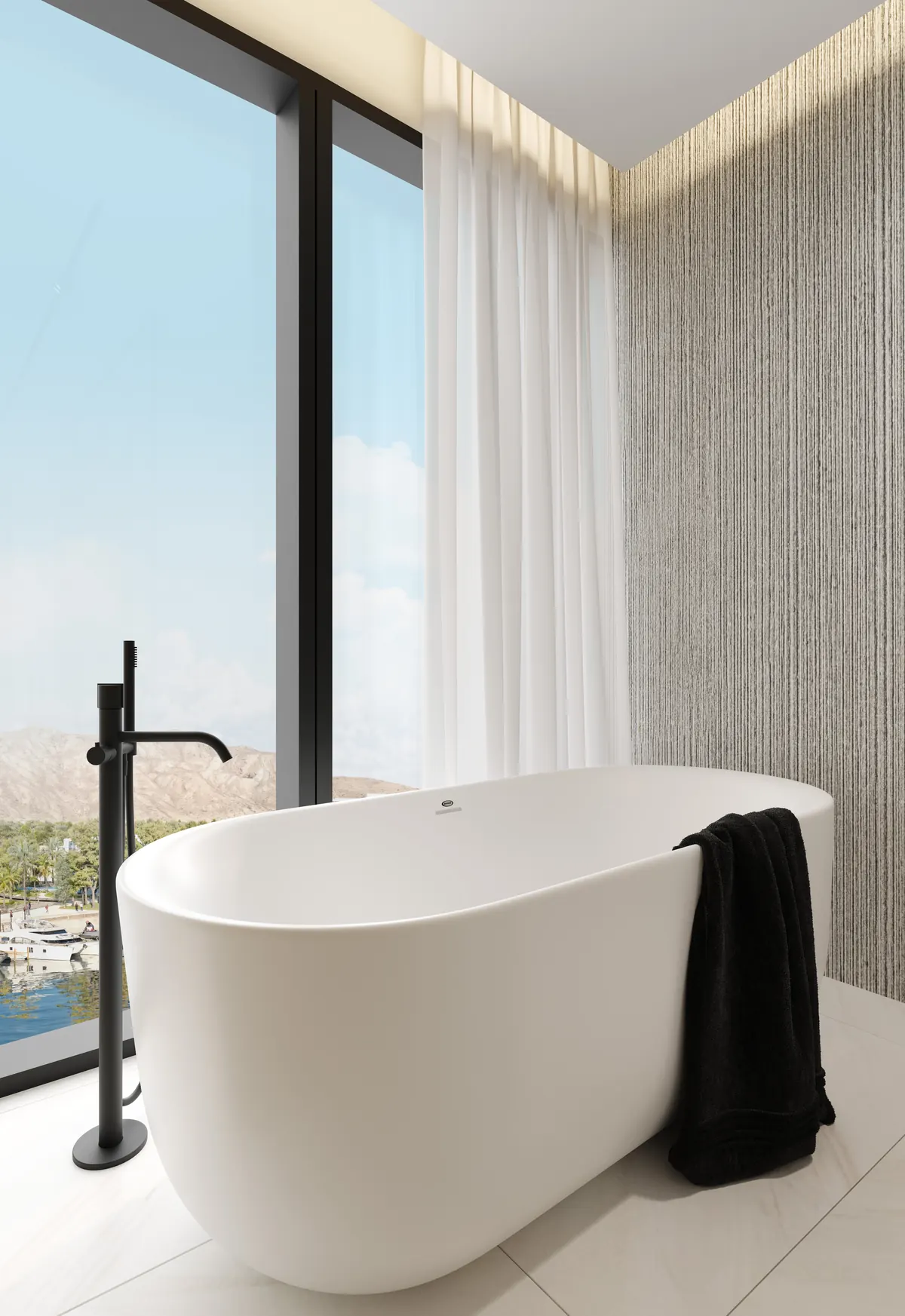 A freestanding bath set against a corner window with a marina outlook